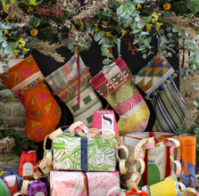 ClothShop by Christopher Farr Cloth Christmas Stocking Collection hanging on a a fire place.