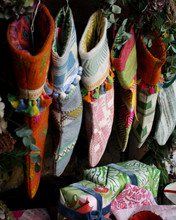 ClothShop by Christopher Farr Cloth Christmas Stocking Collection hanging on a a fire place showing the detail and lining of each.