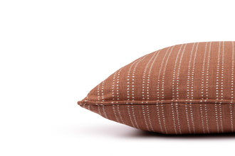 Algonquin linen cushion in terracotta stripe with piping, designed for sophisticated and refined interior settings.