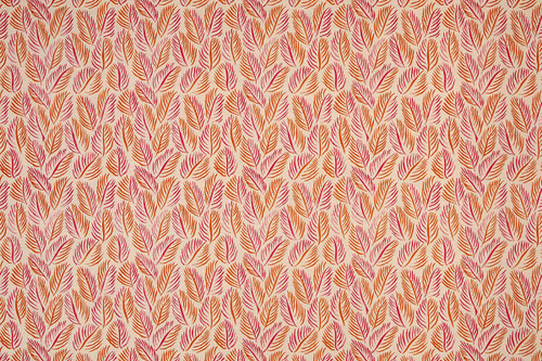 Armatures Feuilles luxury printed linen fabric featuring a vibrant hot pink and orange leaf design, showcasing the fine texture and bold, colourful pattern.