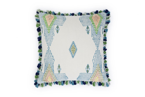 Front view of Travelling Light Teal cushion featuring vibrant teal, green, and blue geometric and triangle patterns with yellow and orange accents, finished with green Jamboree fringe trim.