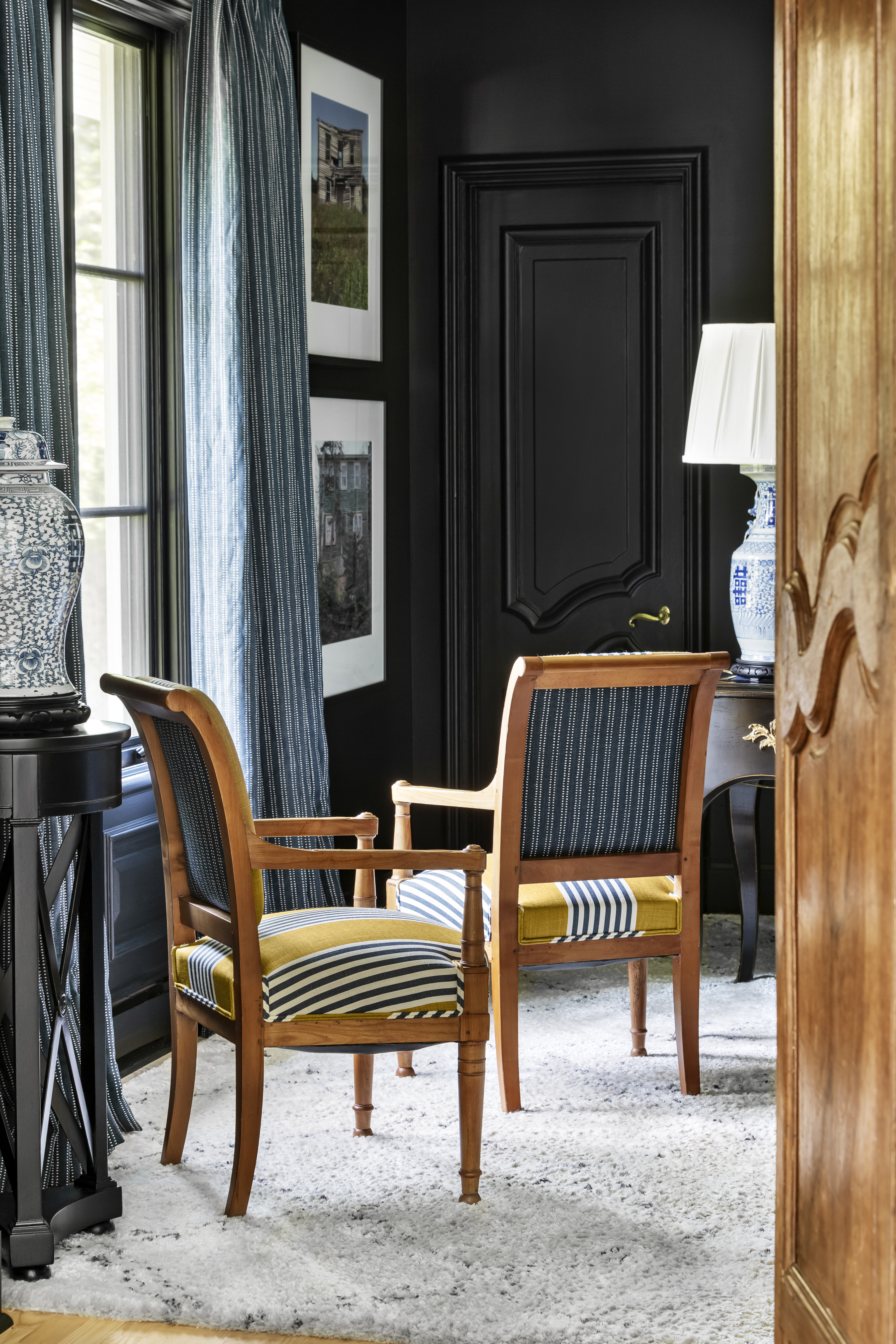 Scott Yetman’s country home in Florida featuring a tailored mix of classic and modern design, with Algonquin fabric by Christopher Farr Cloth used for curtains and upholstery against striking black interior walls.