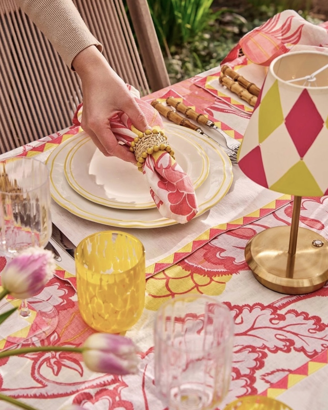 Álvaro Picardo hand-painted lampshades illuminating a table setting with Maison Margaux bespoke Carnival fabric table linen and Bigtop tape, styled with Maison Margot tableware. Photo by Milo Brown.