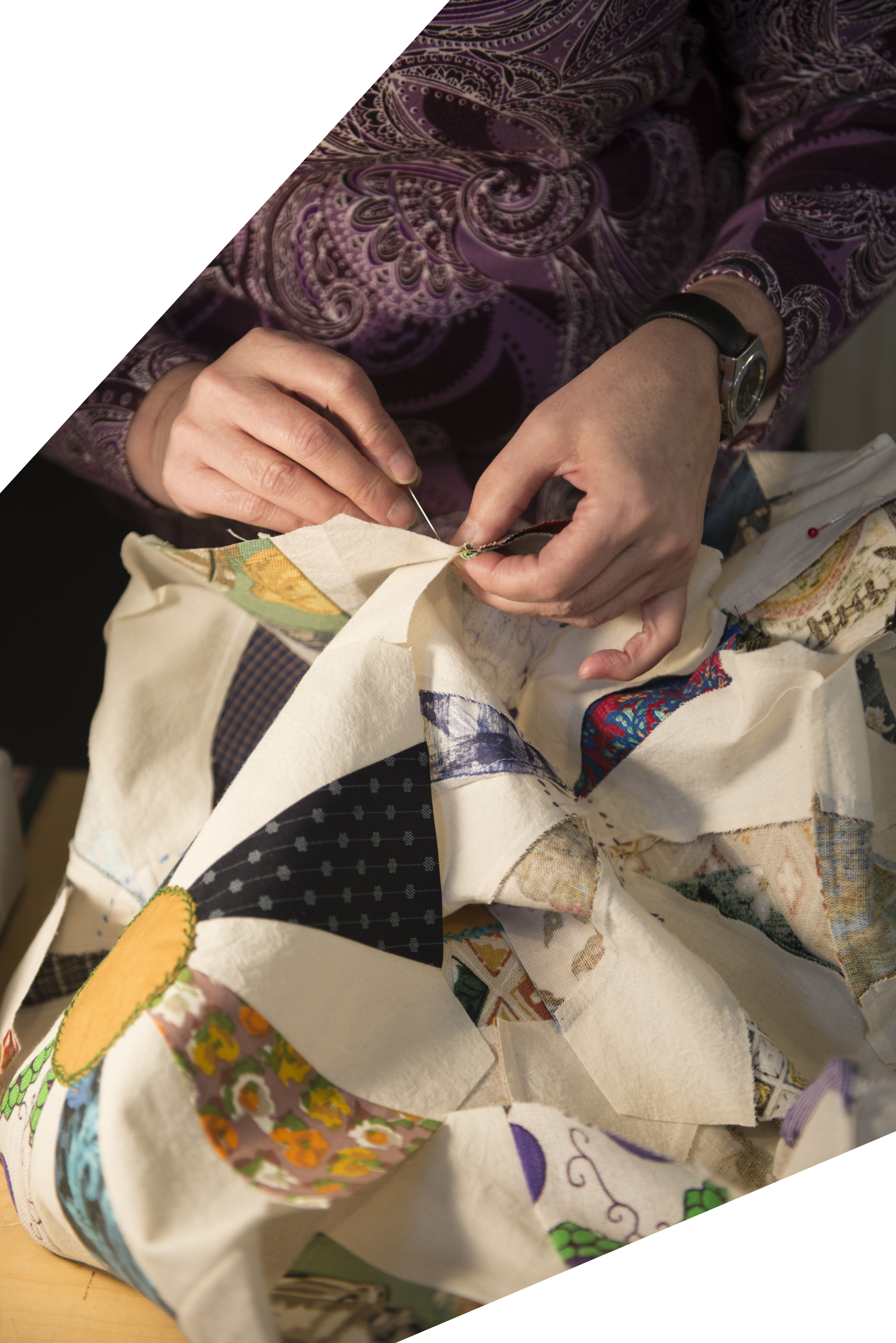 Fogo Island Quilters Portrait - Above view of lady hand quilting in Fogo Island