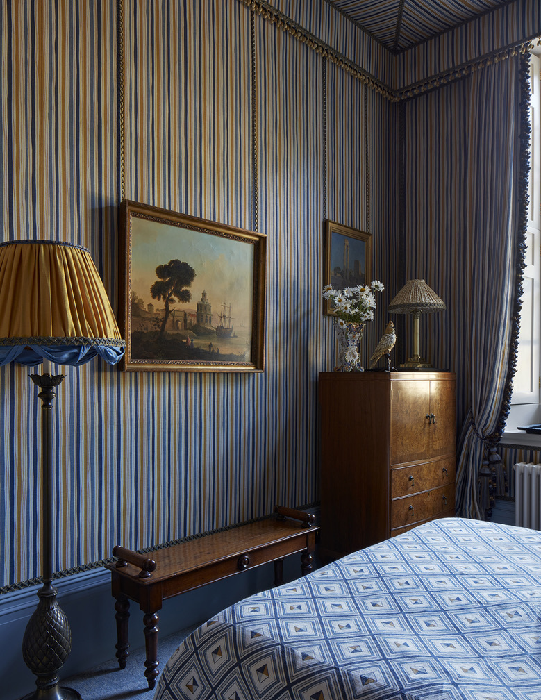 Another angle A contemporary take on royal grandeur, this bedroom by MBDS features Boundary in Ochre cascading from a canopy, layered with Fresco cushions in deep indigo. Dramatic, elegant, and unapologetically cool—a space where soft structure and graphic print reign.