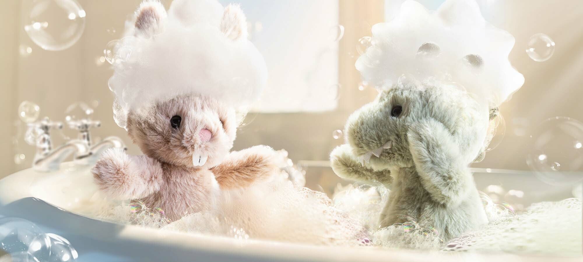 Zwei Jelly Dinos spieler in einer Badewanne mit Badeschaum