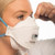 Women adjusting 3M Aura 9322+ Gen3 FFP2 Respirator Face Mask