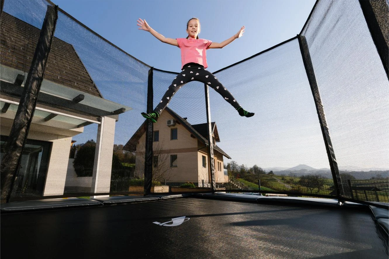 Akrobat Orbit rectangular trampoline with anthracite safety pad in use