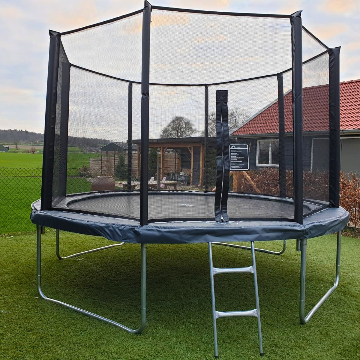 Akrobat Orbit round trampoline with anthracite safety pad at a customer installation