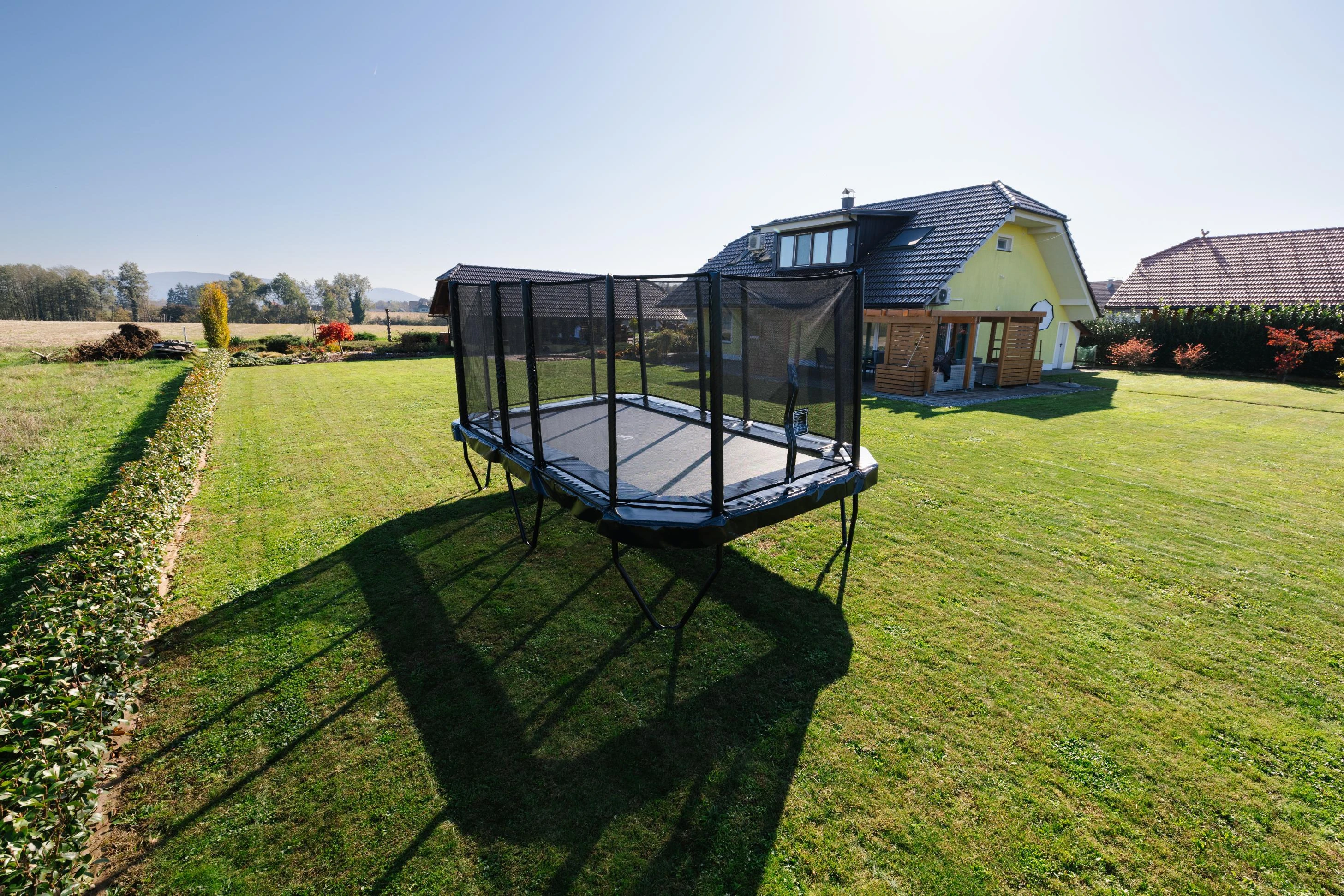 Akrobat Primus Challenger PLUS 17x10ft trampoline on a lawn
