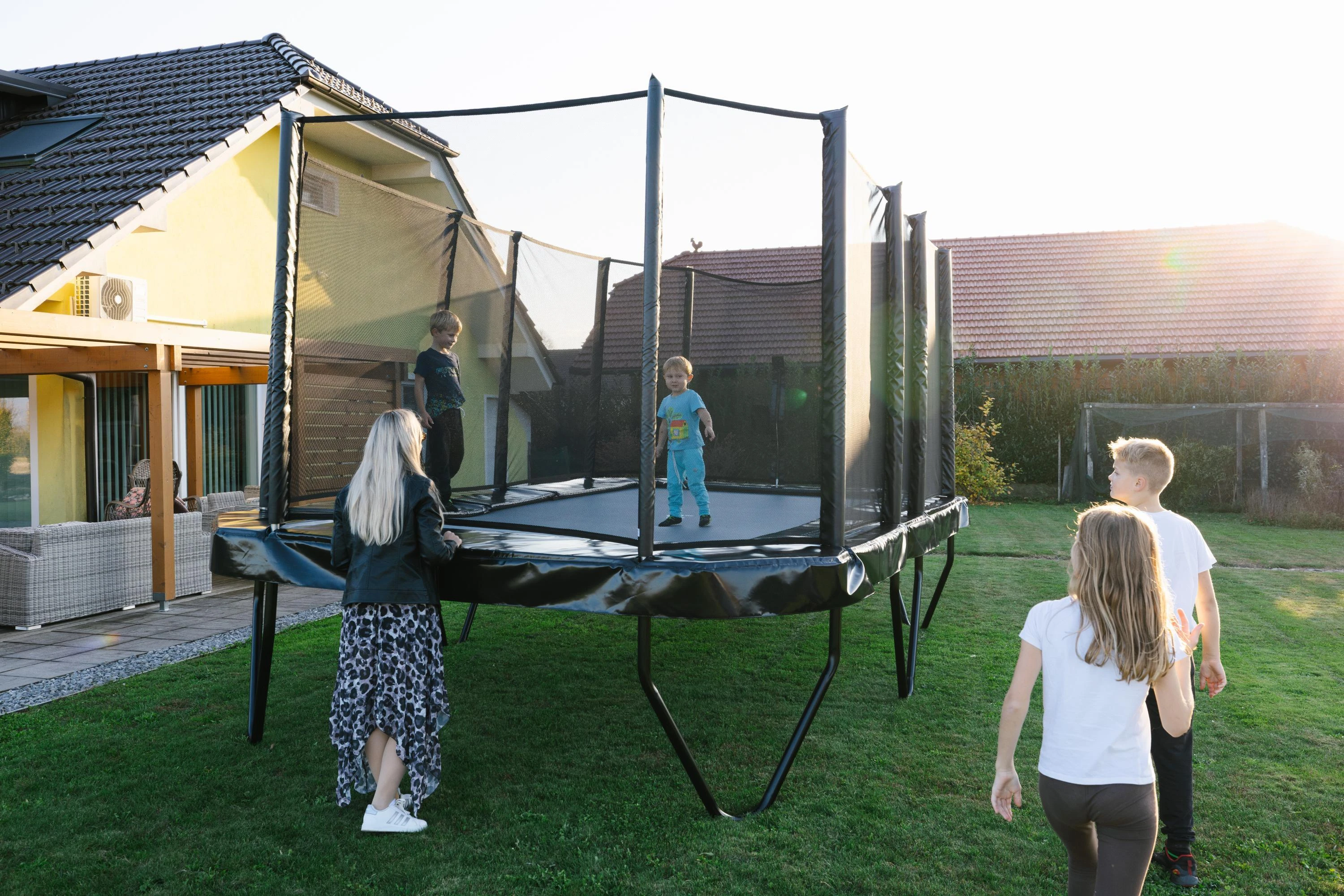 Akrobat Primus Challenger PLUS 17x10ft trampoline in a family garden