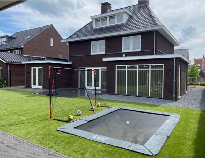Customer photo of an Akrobat Primus Flat rectangular trampoline installed in a garden