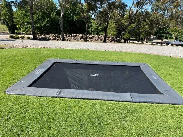 Customer photo of an Akrobat Primus Flat rectangular trampoline installed in a garden