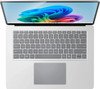 Straight overhead view of the clean platinum backlit keyboard deck and precision haptic trackpad area.