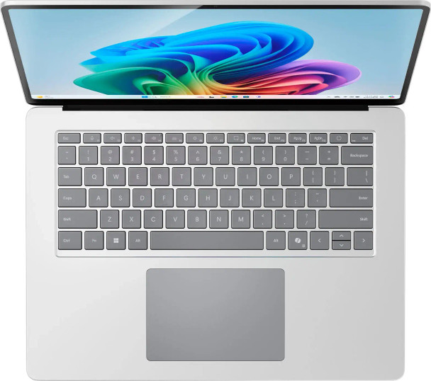 Full overhead perspective of the premium platinum backlit keyboard layout and wide precision haptic touchpad.