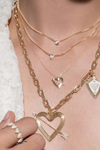 Adina Reyter XL Pave Heart Arrow Charm on gold chain stacked with other chain and charms