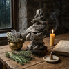 Baba Yaga statue on a wood table at our witch jewelry and supply store