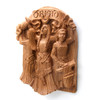 Right-angled view of the Celtic Brigid wall plaque by Paul Borda, showing the intricate carving of the goddess working at an anvil with a hammer to symbolize her aspect of smithcraft