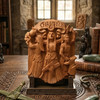 Natural wood finish Brigid wall plaque by Paul Borda sitting on a display stand upon an intricately carved wooden table in a Celtic-themed room