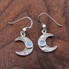sterling silver Celtic crescent moon earrings on solid wood table