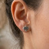 Raven stud earrings: Close-up of a silver Celtic raven earring worn comfortably on a model's earlobe