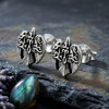 Celtic raven earrings: Silver studs resting on dark slate next to dried lavender and a polished blue stone