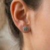 Celtic raven stud earrings: Close-up of a silver knotwork bird earring worn comfortably on a woman's earlobe
