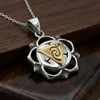 Manipura necklace at our pagan jewelry store crafted with a sterling silver petal frame and a golden triangle center on a wooden surface