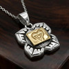 Chakra pendant for the Root Chakra at our pagan jewelry store resting at an angle on a rich, dark wood surface