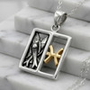 Sterling silver Pisces: Horoscope pendant featuring two silver fish and gold sign resting on white marble