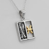 Pisces pendant: Close-up of a two-tone astrological necklace highlighting the textured silver fish design