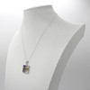 Gemini jewelry mystical horoscope necklace presented on a white jewelry bust, highlighting the striking contrast of silver and gold metals