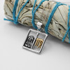 Virgo jewelry mystical horoscope necklace draped delicately over a bundle of dried sage, showcasing the high-quality .925 sterling silver and gold craftsmanship