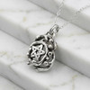 Druid necklace featuring a Celtic pentagram, an elegant sterling silver amulet and pentacle resting gently on white marble steps