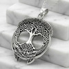 Celtic tree necklace displayed on white marble steps, featuring a highly detailed sterling silver tree pendant with a textured, stippled canopy