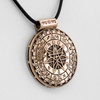 Bronze Pagan wheel necklace close-up angled to the right, showing the thick ridged edge and deeply engraved magical symbols against a clean white background