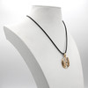 Bronze pentagram pendant displayed on a white jewelry bust, demonstrating the hanging scale and black cord of this nature-inspired Wiccan necklace