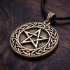 Celtic Pentacle necklace resting flat on a rich dark wood grain surface at our pagan jewelry store