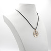 Gold pentacle displayed on a white jewelry bust, demonstrating the hanging scale and black cord of this beautiful pagan pendant