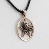 Pagan jewelry close-up angled to the right, highlighting the smooth, open star design behind the detailed, three-dimensional bronze raven