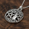 Large pentacle necklace crafted from sterling silver, showing a beautiful tree of life with intricate branches on a dark wood grain background