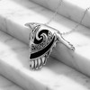 Spirit animal Celtic raven pendant crafted in sterling silver with black spiral details, elegantly draped over white marble steps