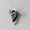 Witch raven familiar pendant, close-up angled to the left, showcasing the sleek silver crow head, black stones, and Celtic knotwork wing