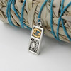 Cancer astrology pendant in sterling silver and gold vermeil, highlighting the intricate three-dimensional metalwork of the crab's shell and claws