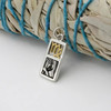 Virgo necklace and zodiac charm in sterling silver and gold vermeil, draped over white sage with a blue cord