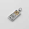 Zodiac charm for Libra angled on a white surface highlighting the two-tone silver and gold finish