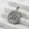 Trinity Knot Pendant and Celtic protection amulet resting on white marble steps, an impressive large trinity knot necklace cast in .925 sterling silver