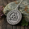 Large triquetra pendant resting on a natural stone at our Wicca jewelry store, a rugged Triquetra Necklace for men crafted as a Celtic protection amulet in solid .925 sterling silver