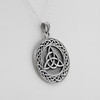 Left-angle close-up of a large triquetra pendant, emphasizing the textured background and polished knotwork of this .925 sterling silver Triquetra Necklace for men
