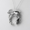 Left-angle close-up of a large dragon pendant, emphasizing the detailed craftsmanship of this sterling silver dragon necklace and dragon moon necklace